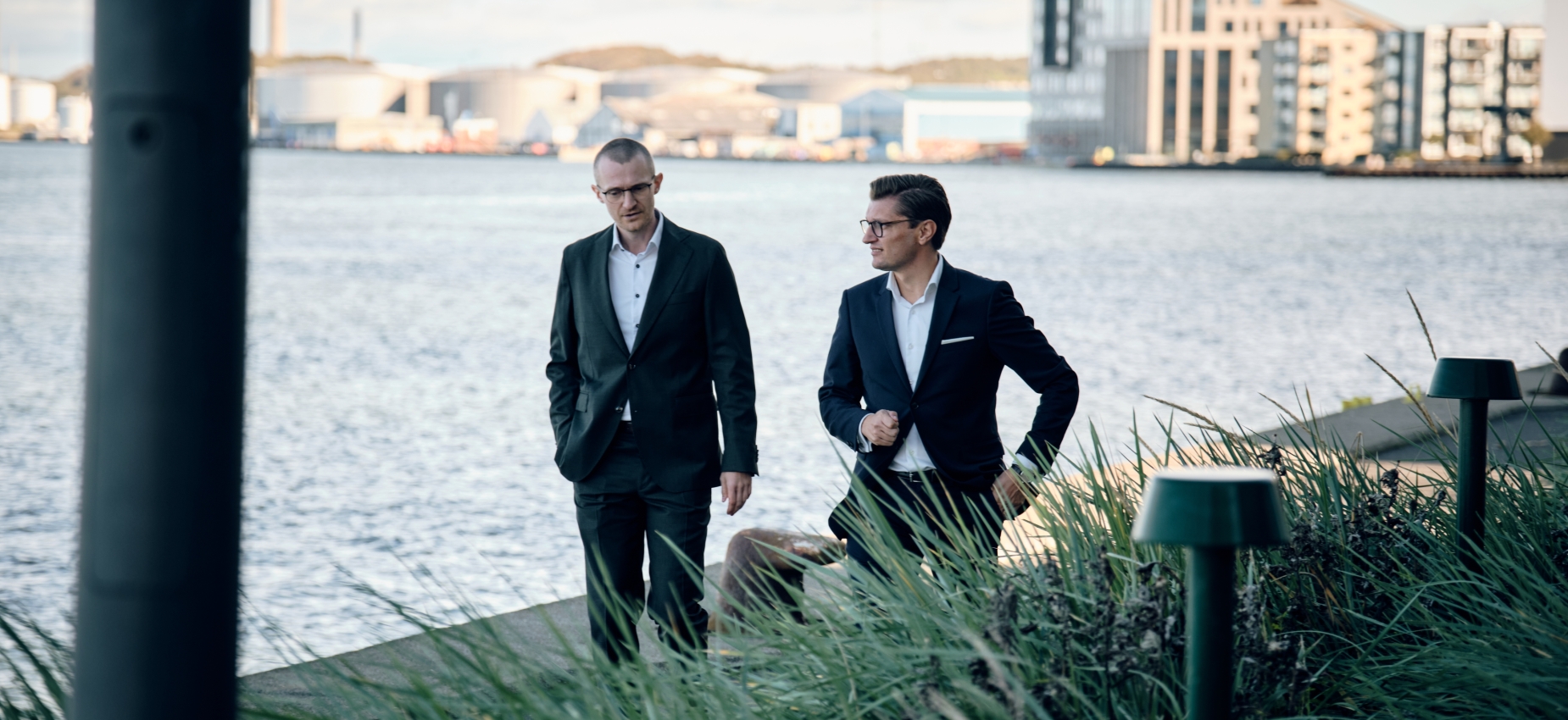 BenderKrøger partners Lars Bender and David Kjølby Krøger walking along the harbour front