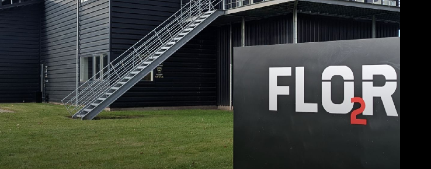 FLO2R headquarters with sign and the text "FLO2R enters strategic partnership with BKP Group"