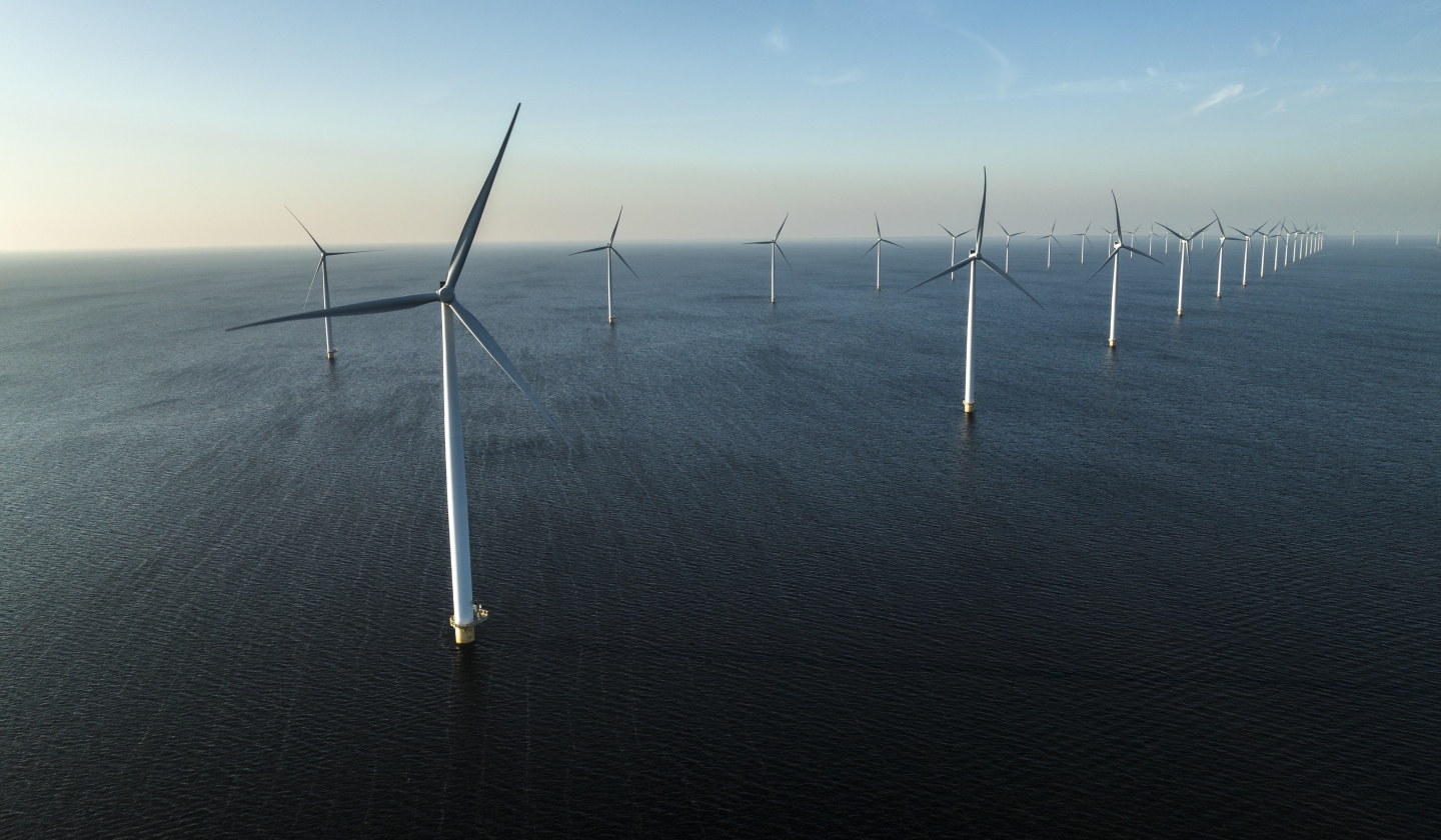 Offshore wind farm with rows of wind turbines at sea