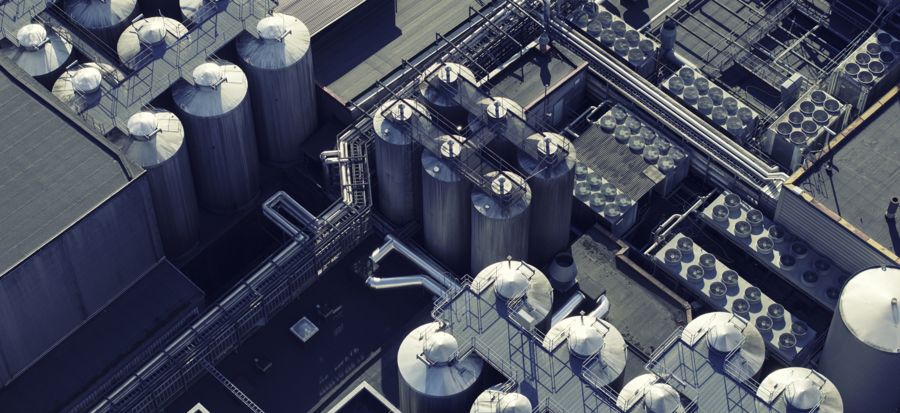 Aerial view of an industrial energy plant with storage tanks and pipework